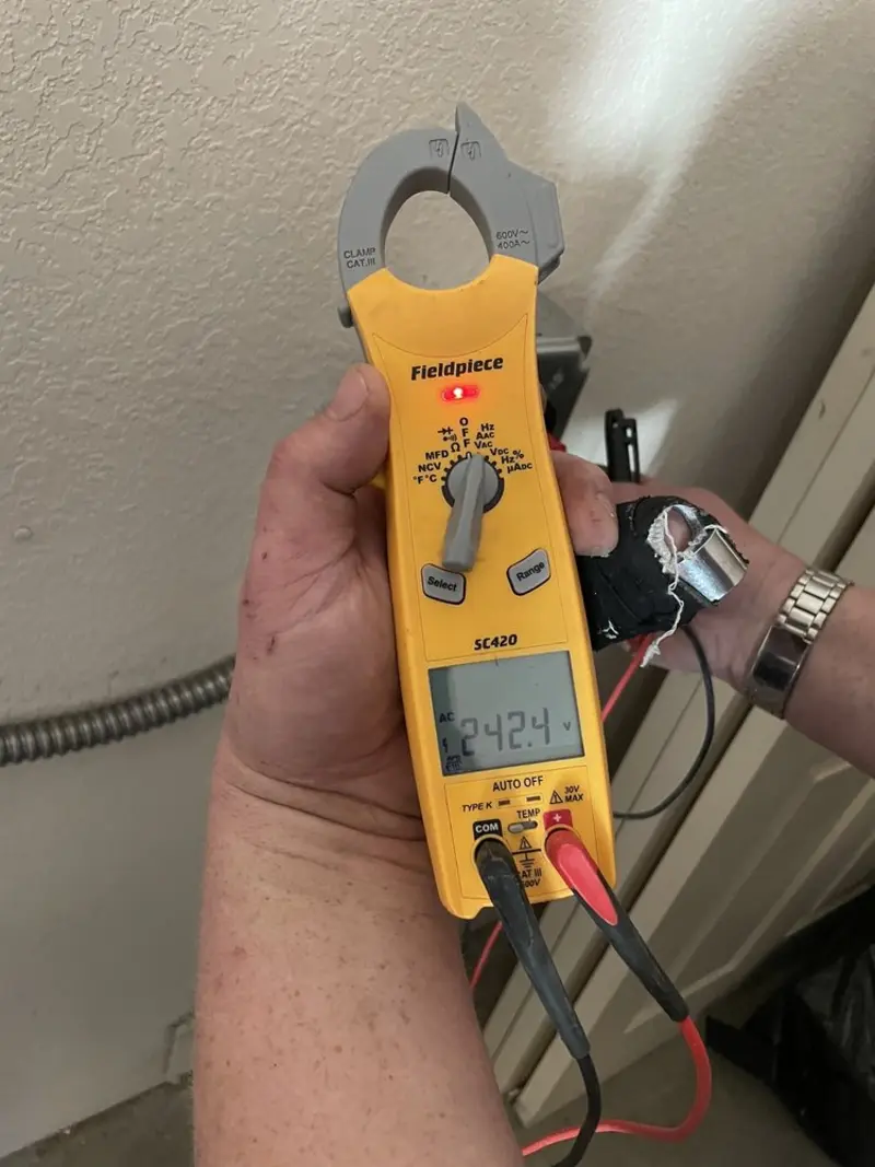 Voltage testing with clamp meter during Electrical Installation Services in Amherst
